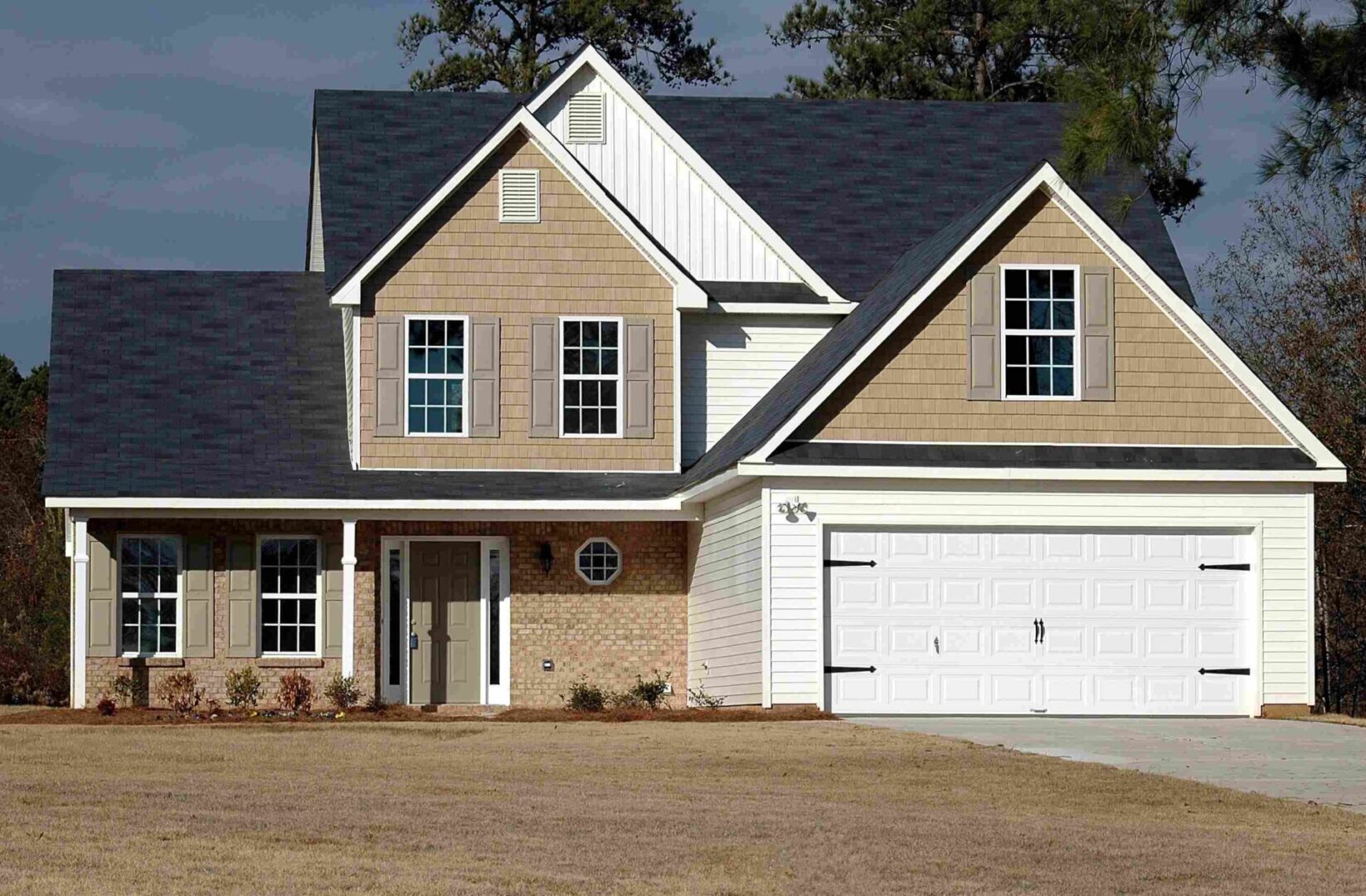 A house with two garage doors and a driveway.